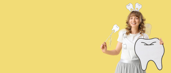 Tooth Fairy with wand and paper figure on yellow background