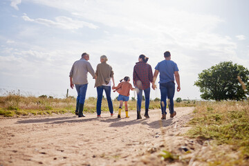 Holding hands, family and walking with kid on farm for love, care or support with grandparents on dirt road. Back, mother and father with girl in countryside for travel, agriculture and generations