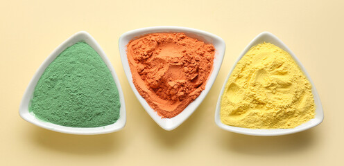 Plates with bright powder pigments on color background