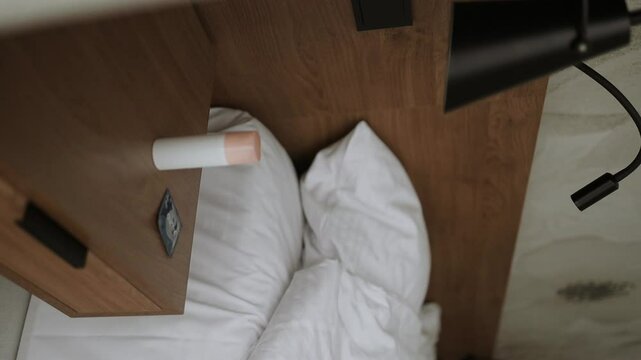 Condom and gel in a bottle in bedside table or nightstand drawer. High quality FullHD footage