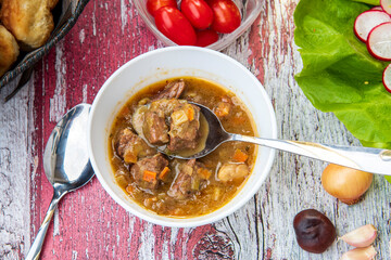 Beef stew with vegetables on a wooden table... cow meat stew