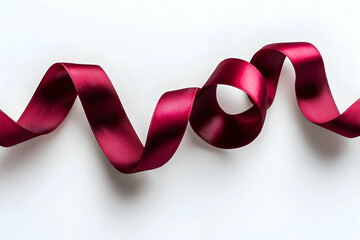 A red satin ribbon curled into a spiral against pure white background.
