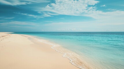 Serene Beach Landscape with Soft Waves under Clear Blue Sky