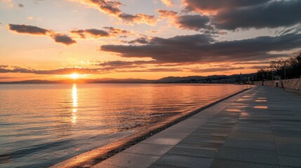 Serene Sunset Over Calm Waters Along Coastal Walkway at Dusk
