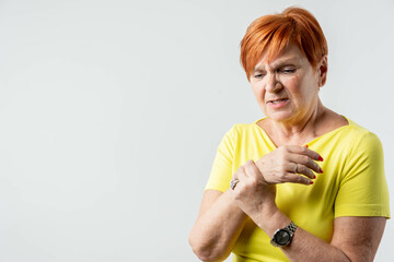 Elderly woman applying moisturizing lotion cream on hand palm, easing aches. Senior old lady...
