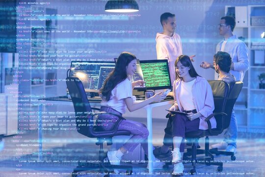 Team of programmers working in office at night