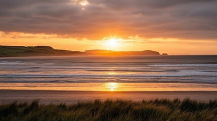 Serene Sunset Over Beach with Gentle Waves and Golden Sky