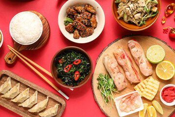 Composition with delicious Chinese dishes on red background