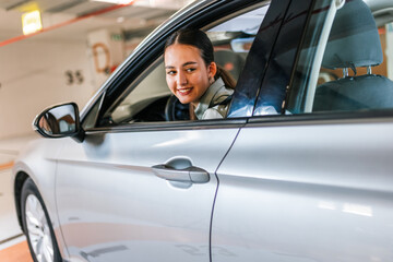 Businesswoman parking in reverse in an underground garage.