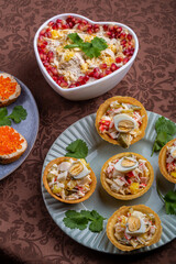 Salad with chicken, pineapple and pomegranate in a heart-shaped salad bowl