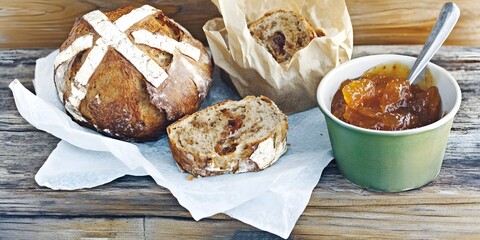 Artisan Bread with Apricot Jam: A rustic, freshly baked loaf of sourdough bread, sliced open, revealing its soft, chewy texture. Beside it, a small green bowl holds a spoonful of vibrant.