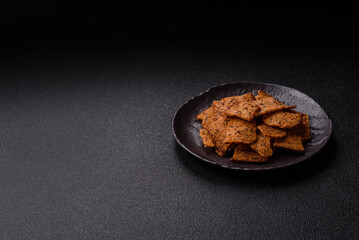 Crispy homemade brown bread chips with seeds and grains