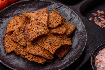Crispy homemade brown bread chips with seeds and grains