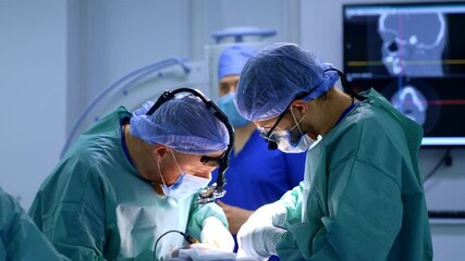 Confident male surgeon uses electric device and metal tool at operation. Maxillofacial surgery in progress. - Powered by Adobe