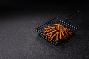 Crispy homemade brown bread crackers or croutons with seeds and grains