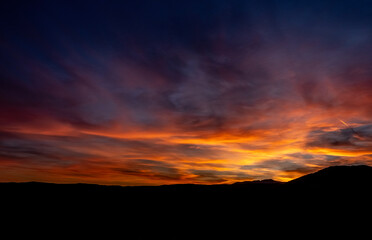 Fototapeta premium Spectacular sunset with cloudy sky with copy space as a background for posters or banners.