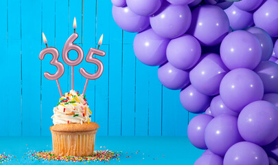 Three candles forming the number 365 - Blue background.