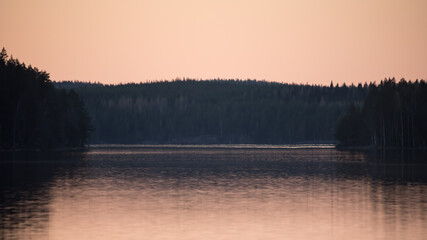 Fototapeta premium Lake scenery around sunset on a late spring evening in conifer forests of Finland