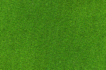 Artificial grass, covering. Artificial green grass mat, top view. Texture. Background. Artificial turf, surface made of synthetic fibers. Flat green grass texture background. Short grass
