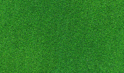 Artificial grass, covering. Artificial green grass mat, top view. Texture. Background. Artificial turf, surface made of synthetic fibers. Flat green grass texture background. Short grass