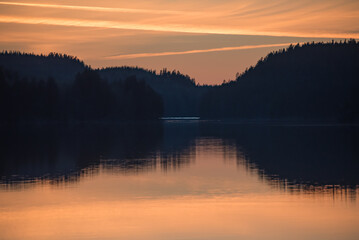 Fototapeta premium Lake scenery around sunset on a late spring evening in conifer forests of Finland