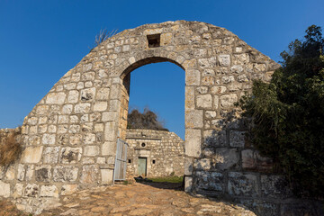Naklejka premium Stone ruins of ancient fortifications on Mount Tabor. Bridge over the moat.