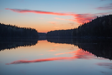 Lake scenery around sunset on a late spring evening in conifer forests of Finland