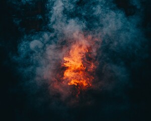 Fototapeta premium Fiery embers glowing in smoke at night; background dark. Use abstract background