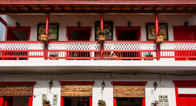 Jardin, Jard&iacute;n, Antioquia, 08 2 2024 : Beautiful traditional colonial facade in the historical village of Jardin. Colorful and multicolored wooden carved doors, windows, balcony. Hotel La Casona.