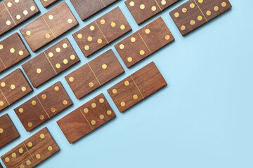 Wooden dominos blocks on blue background