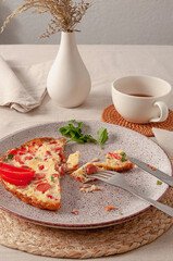 Fried omelette with tomatoes, sausages and fresh herbs for the perfect breakfast