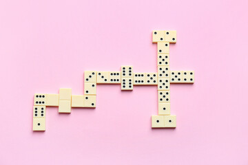 Many white dominos blocks on pink background