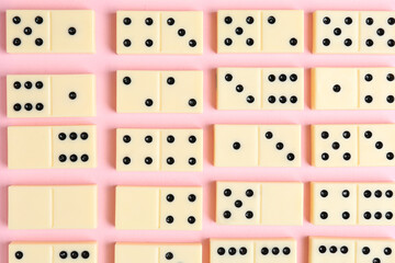 Texture of white dominos blocks on pink background
