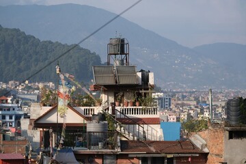 Scenery of roofs of buildings in Kathmandu with water tanks and solar panels, Nepal