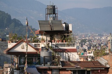 Scenery of roofs of buildings in Kathmandu with water tanks and solar panels, Nepal