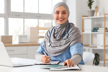Female Muslim doctor in hijab working at hospital