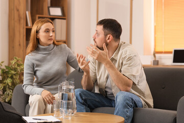 Male drug addict talking to psychologist in office