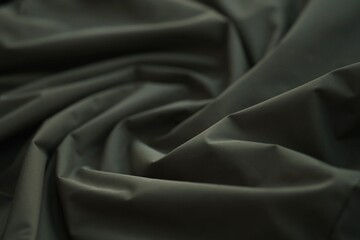 Fototapeta premium Texture of Dark green military uniform textile cloth with folds