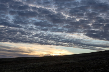 Hill and a sunset cloudscape, Iceland