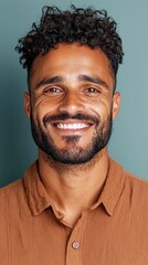 Fototapeta premium Smiling Freckled Man With Curly Hair In Brown Shirt