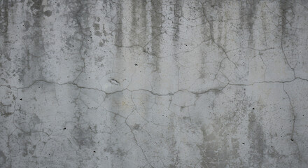 Fototapeta premium Rough concrete wall with subtle cracks and a mix of light and dark gray tones