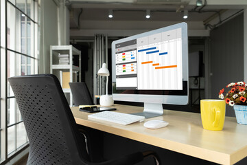Fototapeta premium Project planning software for modish business project management on the computer screen showing timeline chart of the team project