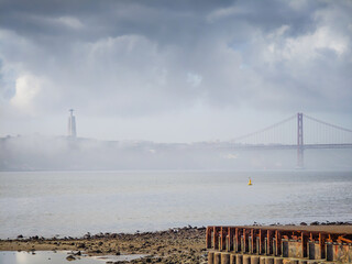 25 April Bridge and Cristo Rei Statue, Tagus river. Panoramic view. Ponte 25 de Abril landmark of Lisbon