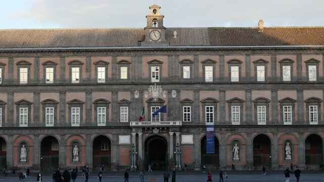 The facade and main entrance of the Royal Palace of Naples, a historic building built in 1600 and located in Piazza del Plebiscito, in the historic center of the city.