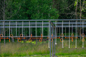 Fototapeta premium playground obstacle course with orange rings.