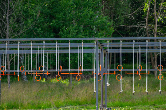 playground obstacle course with orange rings. - Powered by Adobe