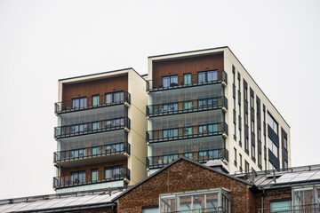 modern apartment building with glass balconies.