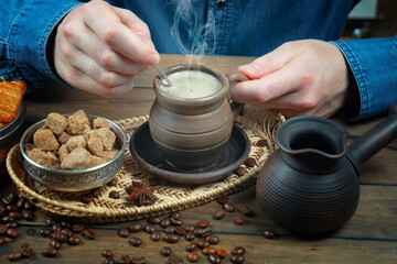 Coffee beans in the hands of an elderly man. Close-up.