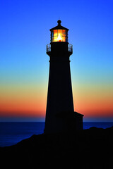 Silhouette of a lighthouse at sunset over the ocean. The light beam shines brightly, symbolizing guidance, hope, and safety, with the calm sea in the background.