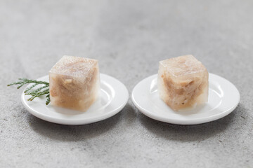 Cold appetizer. Chicken jellied meat in the shape of a mini cube